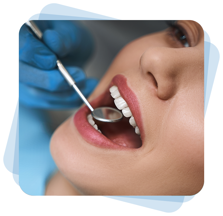 A close-up of a dentist examining a patient's teeth with a dental mirror.